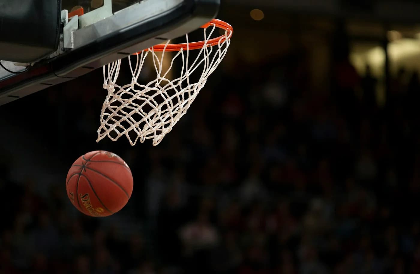 A basketball dropping through the hoop